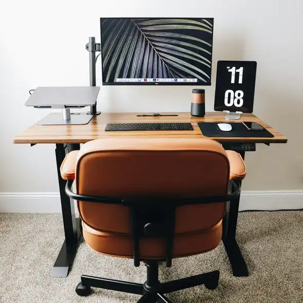 Setup minimalista con mesa escritorio elevable eléctrica, pantalla y accesorios organizados, ideal para home office con estilo nórdico.